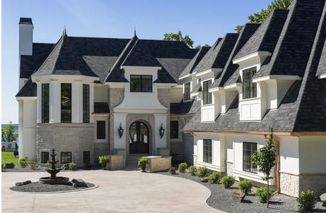 French-country custom home with stone and stucco exterior built by Stonewood
