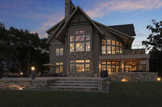 Lakeside custom home at dusk, a Bella Vista Lake Minnetonka project with Eskuche Design